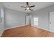 A bedroom is featured with hardwood floors, neutral walls, a ceiling fan, and a window for natural light at 2955 Mt Pleasant Rd, Willow Springs, NC 27592
