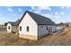Side view of white farmhouse featuring an asphalt roof and black trim at 2955 Mt Pleasant Rd, Willow Springs, NC 27592