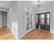 The light-filled foyer features wood-look floors, light gray walls, and a modern lighting fixture at 2955 Mt Pleasant Rd, Willow Springs, NC 27592