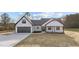 Charming new construction white farmhouse with black trim and two car garage at 2955 Mt Pleasant Rd, Willow Springs, NC 27592