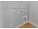 A clean laundry room includes connections for a washer and dryer and wire shelving for additional storage at 2955 Mt Pleasant Rd, Willow Springs, NC 27592