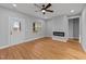 Spacious living room featuring wood-look floors, recessed lighting, modern ceiling fan, and electric fireplace at 2955 Mt Pleasant Rd, Willow Springs, NC 27592