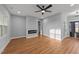 Spacious living room with wood-look floors, recessed lighting, electric fireplace, and two entryways at 2955 Mt Pleasant Rd, Willow Springs, NC 27592