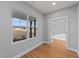 Bright office features wood-look floors, light gray walls, large windows, and an entrance to another room at 2955 Mt Pleasant Rd, Willow Springs, NC 27592