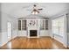 Bright living room with a fireplace, built-in shelving, and a ceiling fan for added comfort at 296 Hornbeam Ln, Willow Springs, NC 27592