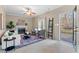 Bright living room boasts fireplace, ceiling fan, neutral walls, and access to deck at 300 Stonehill Rd, Chapel Hill, NC 27516