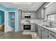 Well-lit kitchen featuring stainless steel appliances, gray cabinets, and a subway tile backsplash at 3108 Selkirk Pl, Raleigh, NC 27604