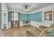 Inviting living room with wood floors, two-tone paint, modern ceiling fan, and natural light at 3108 Selkirk Pl, Raleigh, NC 27604