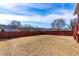 Spacious backyard enclosed by a stylish red fence, offering privacy and ample space for recreation and outdoor enjoyment at 317 Daniel Ridge Rd, Wendell, NC 27591