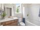 Bright bathroom featuring a vanity with a marble countertop and a shower-tub combination at 322 Umstead St, Sanford, NC 27330