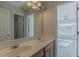Bathroom vanity with double sinks and an open doorway to an adjacent bedroom at 3671 Coach Lantern Ave, Wake Forest, NC 27587