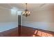 Elegant dining room with hardwood floors, wainscoting, and decorative chandelier at 3671 Coach Lantern Ave, Wake Forest, NC 27587