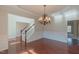 Elegant foyer with hardwood floors, chandelier, and staircase leading to the upper level at 3671 Coach Lantern Ave, Wake Forest, NC 27587