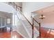 Inviting foyer with a grand staircase, hardwood floors, and elegant chandelier at 3671 Coach Lantern Ave, Wake Forest, NC 27587