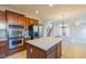 Well-lit kitchen features stainless steel appliances, an island, and tile floors at 3671 Coach Lantern Ave, Wake Forest, NC 27587