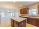 Spacious kitchen with wood cabinets, stainless appliances, and a central island at 3671 Coach Lantern Ave, Wake Forest, NC 27587