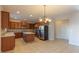 Open kitchen area featuring wooden cabinets, stainless steel appliances, and tile flooring at 3671 Coach Lantern Ave, Wake Forest, NC 27587