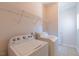 Functional laundry room with washer, dryer, and storage shelves at 3671 Coach Lantern Ave, Wake Forest, NC 27587