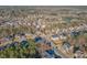 Expansive aerial view of a densely populated neighborhood nestled among lush greenery and mature trees at 3671 Coach Lantern Ave, Wake Forest, NC 27587