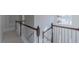 Upstairs hallway shows staircase with white railings and decorative chandelier at 3671 Coach Lantern Ave, Wake Forest, NC 27587