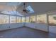 Bright sunroom featuring wood flooring, windows, a ceiling fan and views of the outdoors at 3671 Coach Lantern Ave, Wake Forest, NC 27587