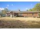 Backyard view of home with a brick exterior and many windows at 41 E T Hanner Rd, Bear Creek, NC 27207