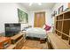Bedroom with a full-size bed, wood floors, and art on the wall at 41 E T Hanner Rd, Bear Creek, NC 27207