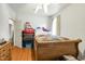 Bedroom with hardwood floors, quilt on the bed, and neutral paint at 41 E T Hanner Rd, Bear Creek, NC 27207