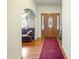 Inviting foyer featuring wood floors, an elegant front door, and a glimpse into the living area at 41 E T Hanner Rd, Bear Creek, NC 27207