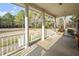 Relaxing covered porch with seating area overlooking a spacious yard filled with mature trees at 41 E T Hanner Rd, Bear Creek, NC 27207