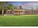 Charming red brick home featuring a welcoming front porch and a well-manicured lawn at 41 E T Hanner Rd, Bear Creek, NC 27207