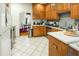 Open kitchen with wood cabinets, white counters, and view into dining room at 41 E T Hanner Rd, Bear Creek, NC 27207