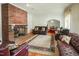 Spacious living room featuring hardwood floors, comfortable seating, and a striking brick fireplace at 41 E T Hanner Rd, Bear Creek, NC 27207