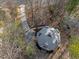 Aerial view of home with unique roof, surrounded by trees and a driveway at 419 Obie Dr, Durham, NC 27713