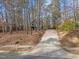 Long driveway leading up to home surrounded by lush trees at 419 Obie Dr, Durham, NC 27713