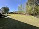 Expansive, well-maintained back yard with lush lawn and mature trees, perfect for outdoor activities at 429 Teague St, Wake Forest, NC 27587