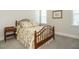 Cozy bedroom with floral bedding, a wooden bed frame, and natural light from nearby windows at 429 Teague St, Wake Forest, NC 27587