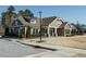 Attractive exterior view of neighborhood clubhouse, featuring stone accents, bench seating, and manicured landscaping at 429 Teague St, Wake Forest, NC 27587