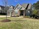 Charming home with a well-manicured lawn, stone accents, and a welcoming front porch at 429 Teague St, Wake Forest, NC 27587