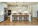 Kitchen featuring white cabinets, stainless steel appliances, a central island, and wooden chairs at the counter at 429 Teague St, Wake Forest, NC 27587