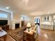 Cozy living room with fireplace, hardwood floors, and view to kitchen area at 429 Teague St, Wake Forest, NC 27587