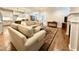 Open-concept living room featuring hardwood floors, a fireplace, and neutral-toned sofas at 429 Teague St, Wake Forest, NC 27587