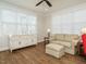 Inviting sunroom filled with natural light, featuring a comfortable couch and storage at 429 Teague St, Wake Forest, NC 27587