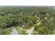 Aerial view of the property surrounded by lush greenery and mature trees in a serene setting at 4705 Bernie Pl, Raleigh, NC 27616