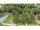 Aerial view showcasing a beautifully landscaped property, surrounded by mature trees and lush lawns at 4705 Bernie Pl, Raleigh, NC 27616
