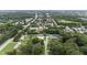 Wide angle aerial view of a home, in a neighborhood, surrounded by lush trees and roads at 4705 Bernie Pl, Raleigh, NC 27616