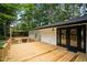 New construction back deck and black framed doors provide access to the home at 4705 Bernie Pl, Raleigh, NC 27616