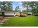 Expansive backyard featuring a wooden deck and lush green lawn at 4705 Bernie Pl, Raleigh, NC 27616