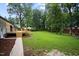 Spacious backyard showing the home's back deck, large yard and mature trees at 4705 Bernie Pl, Raleigh, NC 27616