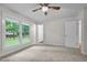 A simple and cozy bedroom with plush carpet and a large window at 4705 Bernie Pl, Raleigh, NC 27616